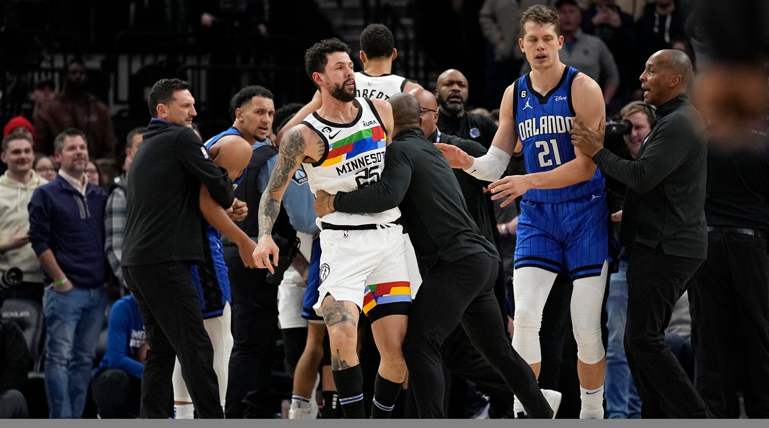 Timberwolves guard Austin Rivers is pulled away from the scrum as players fought.